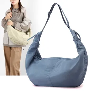 Large capacity blue nylon hobo bag for women featuring a pleated crescent design