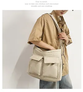 Asian model showing a large beige canvas messenger bag in a literary retro style