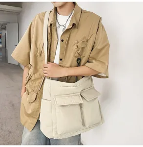 Large off-white canvas messenger bag styled on a male model for everyday casual wear