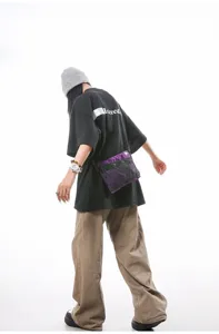 Model wearing a vibrant purple mesh streetwear crossbody bag for outdoor hiking and travel