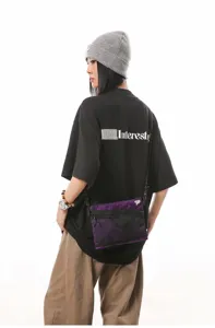 Detail shot of a purple Japanese style workwear crossbody bag worn by a model