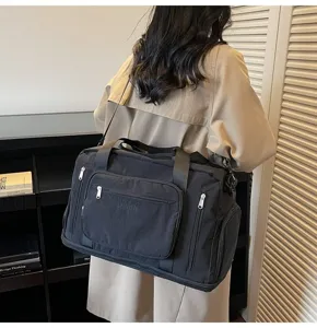 Woman carrying a large black multifunctional travel bag with expandable design