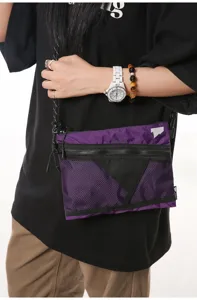 Japanese style purple workwear crossbody bag with mesh front pocket shown on a male model