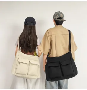 Back view of a couple wearing large capacity canvas messenger bags in black and beige