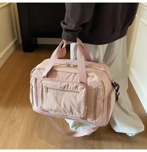 Large capacity pink travel duffel bag with multiple pockets shown in a lifestyle setting