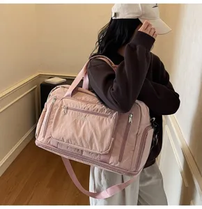 Asian model carrying a high-quality large pink expandable travel bag for gym and trips
