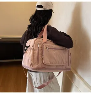 Rear view of a model carrying a pink large-capacity multi-functional travel bag