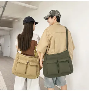 Back view of large capacity canvas messenger bags in khaki and olive green on a couple.
