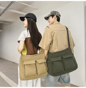 Lifestyle detail view of retro large capacity canvas messenger bags in khaki and green