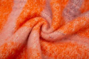 Detailed macro view showing the soft texture of thickened orange striped faux mohair shawl