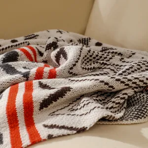 Close-up of Bohemian style knitted blanket showing ethnic patterns and texture.