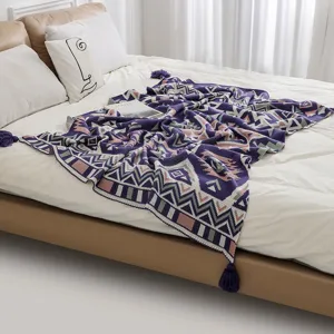 Detailed texture of bohemian knitted throw blanket with ethnic patterns and tassels