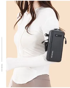 Detailed view of a stylish grey vertical sports arm bag worn on a female model's upper arm