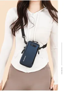 Detailed view of a navy blue crossbody phone bag worn by a model in a casual sports style