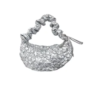 Silver metallic puffy cloud shoulder bag featuring a pleated scrunchie handle design.