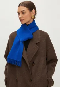 Detailopname van een heldere Klein blauwe gebreide sjaal met franjes bij een model