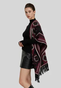 Detail view of bohemian ethnic style knitted shawl with fringe and geometric patterns.