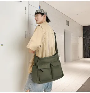 Retro army green canvas messenger bag for men and women, shown in an indoor lifestyle scene