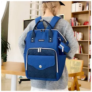 Mochila pañalera de lona azul con diseño acolchado y bolsa de almacenamiento pequeña