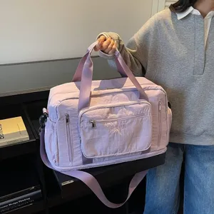 Large purple nylon travel duffel bag with multi-compartment storage for fitness trips