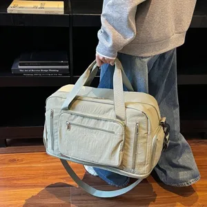Large capacity sage green travel duffel bag with multiple pockets and shoulder strap
