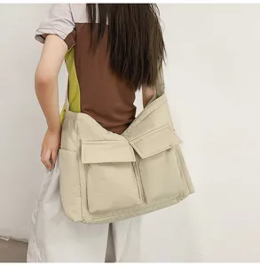 Minimalist beige canvas messenger bag with two front pockets in a vintage forest style