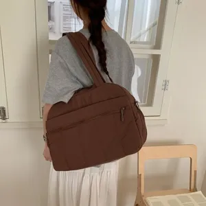 Detailed macro view of a large capacity brown quilted travel bag in a lifestyle scene