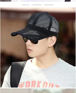 Breathable black mesh baseball cap for men, detailed view worn by model outdoors.