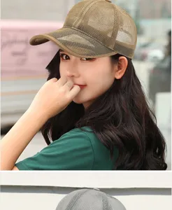 Close-up of a breathable khaki mesh baseball cap worn by a model in daylight