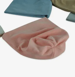 Close-up of soft polar fleece beanies in various colors for winter warmth