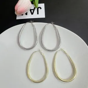 Elegant large teardrop hoop earrings in matte gold and silver geometric design