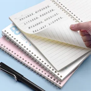 Close-up of premium thick paper pages being turned in a minimalist spiral bound notebook