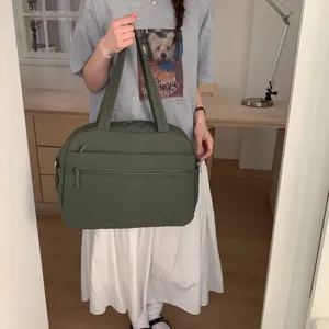 Detail of large capacity olive green quilted travel bag for women short trip