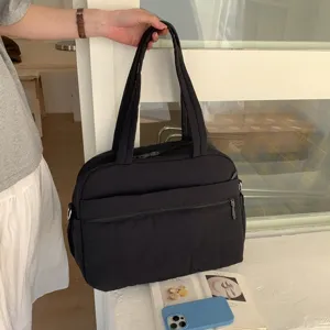 Black large capacity cloud travel bag detail showing quilted texture and front pocket