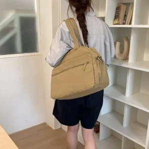 Large capacity khaki cloud travel bag shown on shoulder for gym or weekend trips