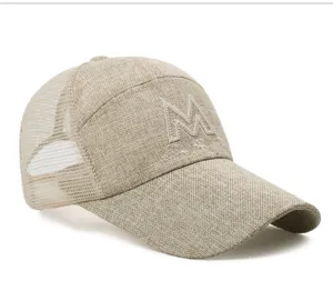 Close-up detail of a beige linen mesh baseball cap featuring an embroidered M logo design