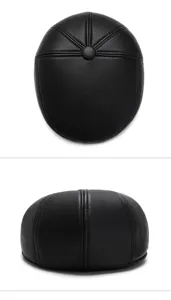 Detailansichten der Steppnähte und Textur einer hochwertigen schwarzen Herren-Leder-Schiebermütze
