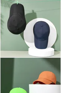 Close-up detail of quick-dry baseball caps in multiple colors on minimalist pedestals