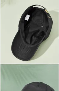 Detail view of the breathable mesh lining and wash label of a black quick-dry baseball cap