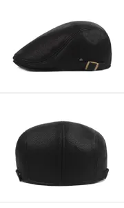 Detail view of black faux leather newsboy cap showing texture and side buckle detail