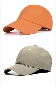 Detailed view of quick-dry breathable blank baseball caps in orange and olive green