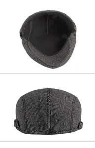 Detailed view of grey herringbone newsboy cap showing interior lining and back exterior.