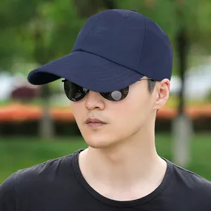 Plain dark blue quick-dry baseball cap for large head sizes shown on a model outdoors