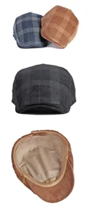 Detail view of corduroy plaid beret hats showing interior lining and multiple color options