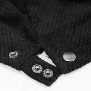 Close-up detail of black corduroy beret hat featuring functional metal snap fasteners