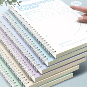 Detailed view of stacked pastel A5 spiral notebooks for students with cute cover designs