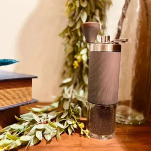 Close-up of manual coffee grinder with wood grain finish and glass container