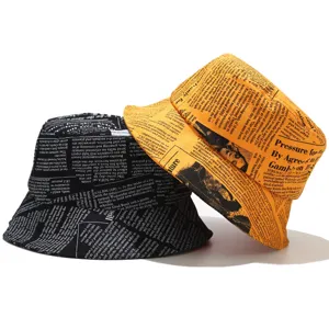 Newspaper print bucket hats in black and orange for streetwear summer sun protection