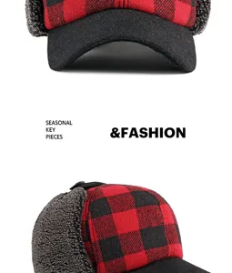 Detail view of a red buffalo plaid winter trapper hat with warm grey fleece lining