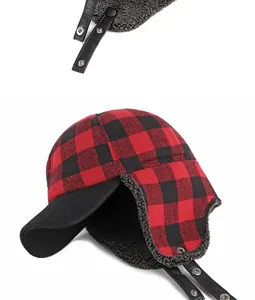 Detailed view of red and black buffalo plaid winter trapper hat with warm fuzzy lining.
